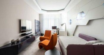 Decoração futurista em sala de estar com poltronas laranjadas
